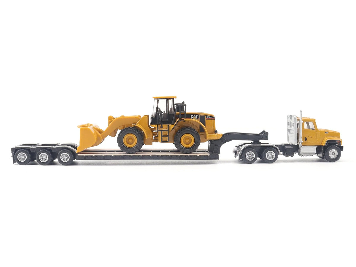 Yellow CAT Caterpillar CT681 day cab tractor with lowboy trailer and CAT 950G wheel loader diecast model in 1/87 scale by Diecast Masters