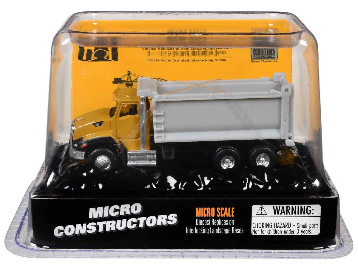 Yellow Caterpillar CT660 dump truck diecast model from the Micro-Constructor series by Diecast Masters, detailed construction model.