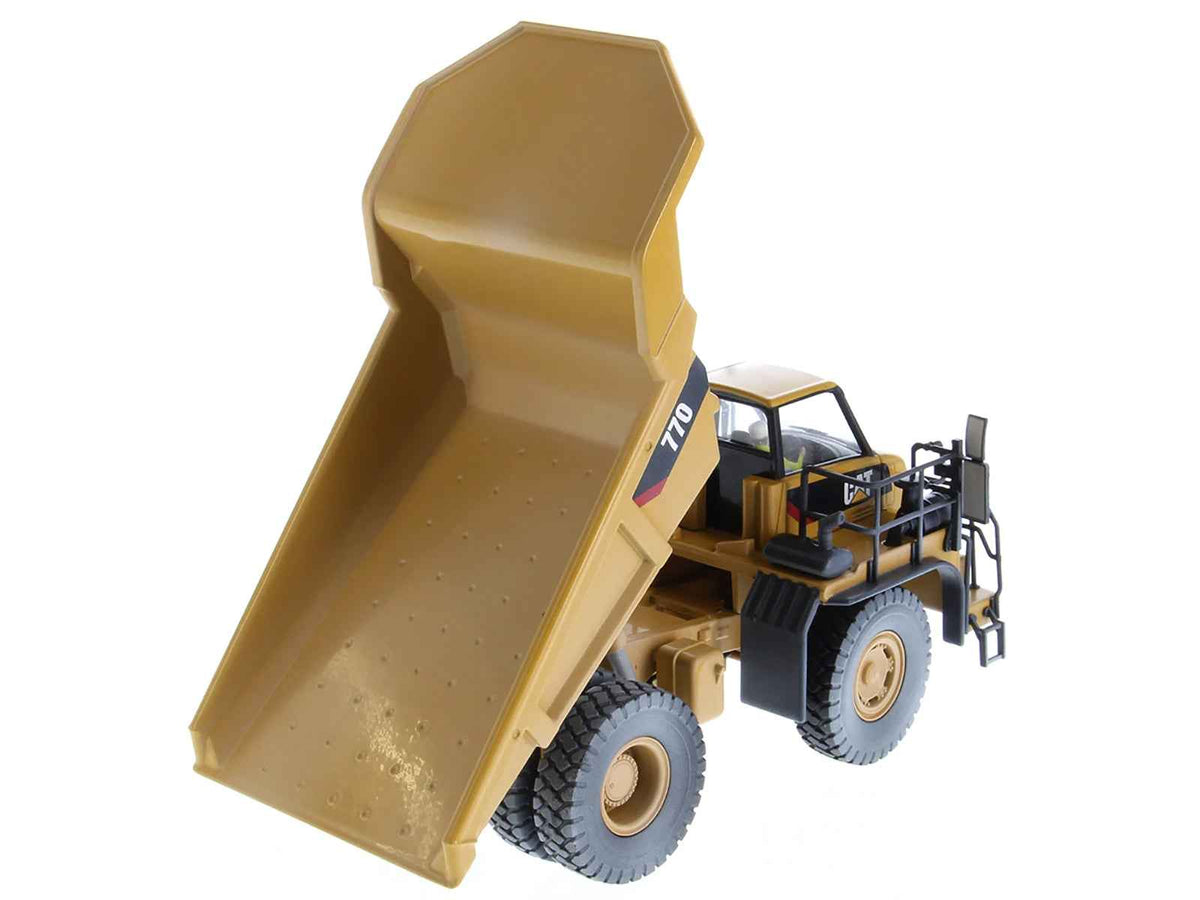 Weathered yellow CAT Caterpillar 770 off-highway truck diecast model with operator figure, detailed construction model by Miniature Motors