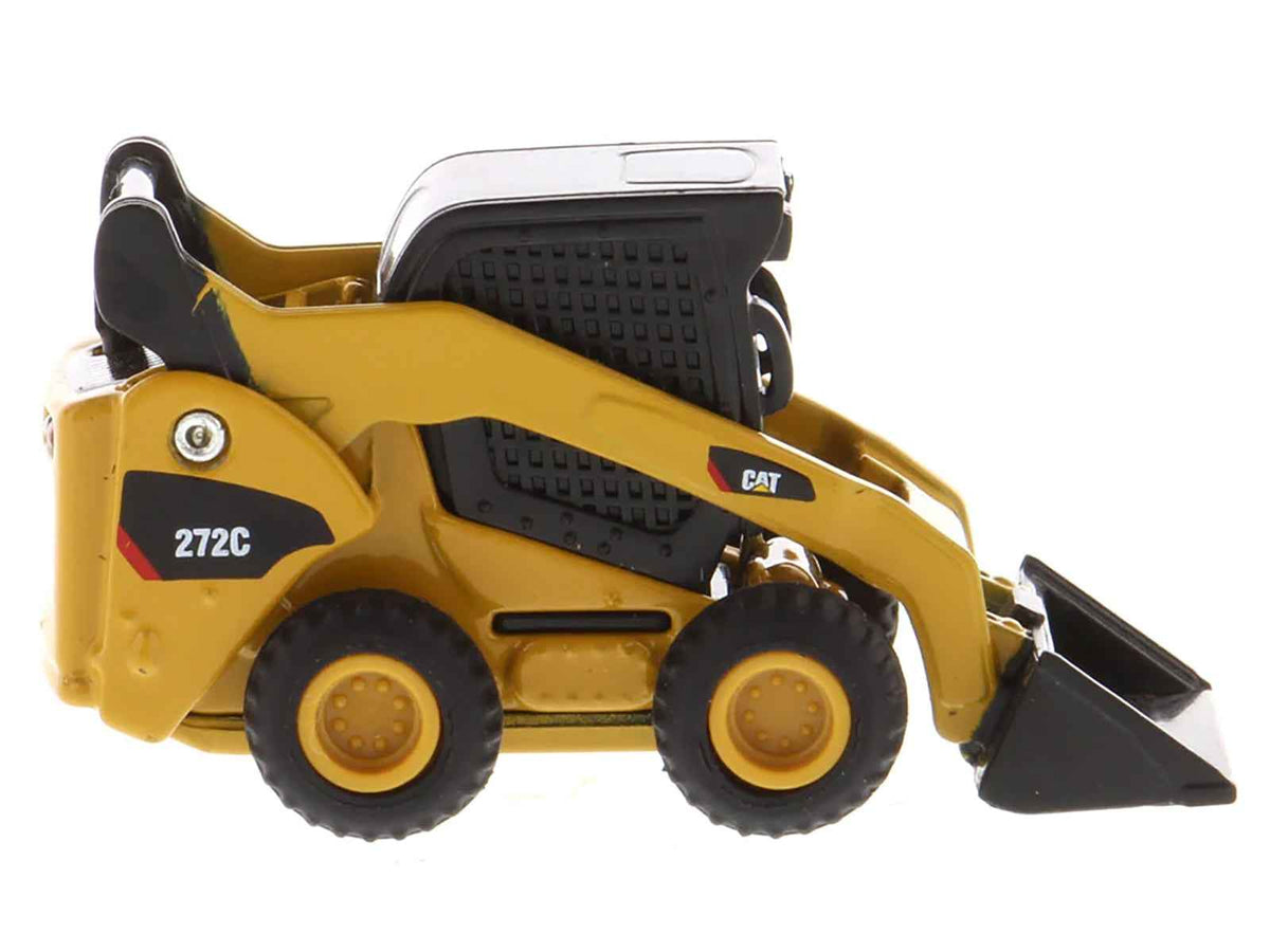 Yellow Caterpillar 272C Skid Steer Loader diecast model from Miniature Motors, part of the Micro-Constructor series.