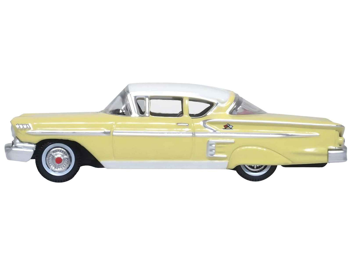 1958 Chevrolet Impala Sport diecast model car by Oxford Diecast, colonial cream color with white top, 1/87 scale, detailed miniature.