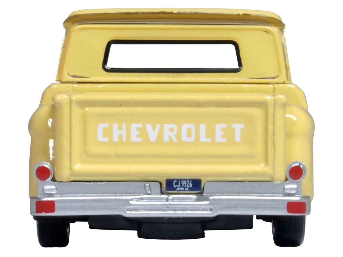 Yellow 1965 Chevrolet C10 Stepside Pickup Truck diecast model by Oxford Diecast, 1/87 scale, detailed miniature vehicle.