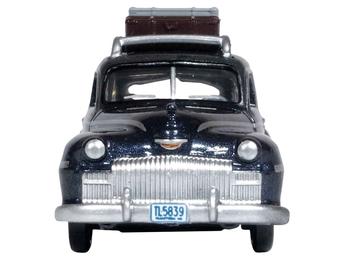 Miniature Motors 1/87 scale diecast DeSoto Suburban model car in butterfly blue metallic with roof rack and luggage, crystal gray top.