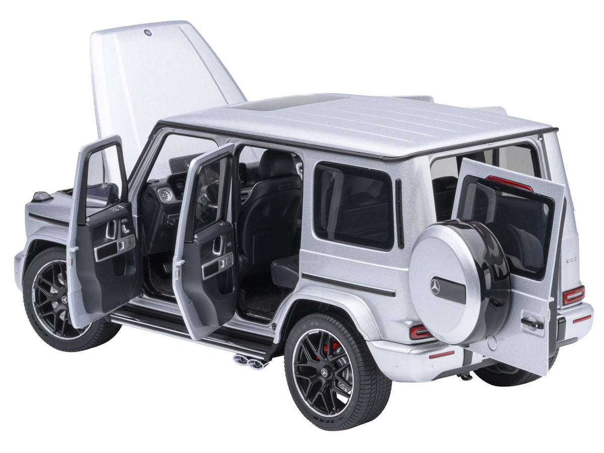 Miniature 1/18 scale Mercedes-Benz AMG G63 model car in iridium silver metallic by Autoart, detailed collectible vehicle.