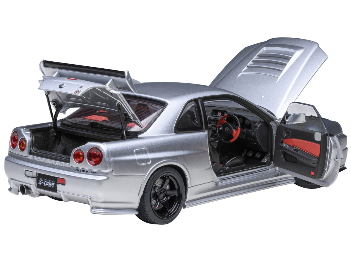 Silver metallic Nissan Nismo R34 GT-R Z-TUNE 1/18 scale model car by Autoart, showcasing detailed exterior and right-hand drive features.
