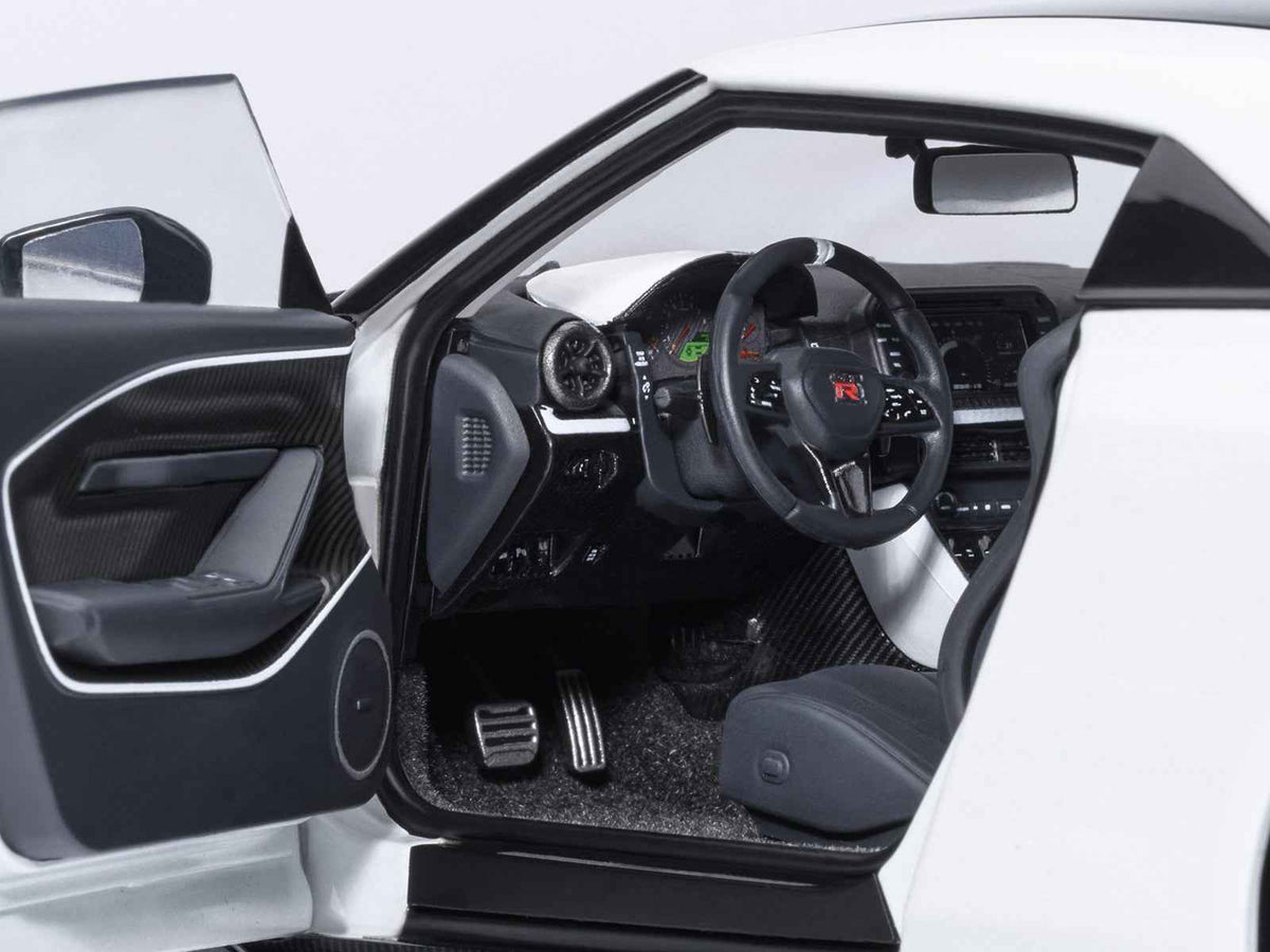 Miniature Nissan GT-R50 by ItalDesign model car in black and white metallic, 1/18 scale, detailed Autoart collectible.