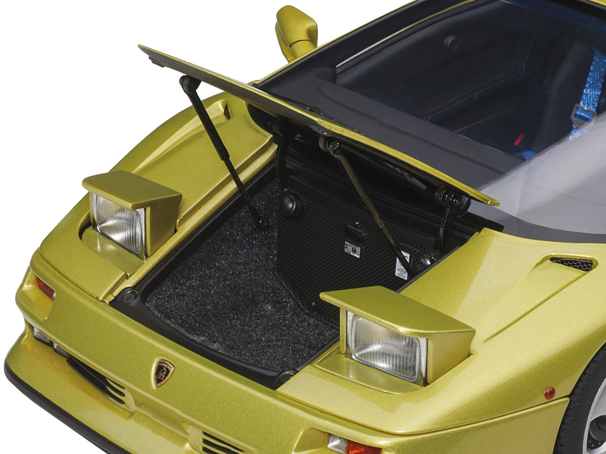 Miniature Lamborghini Diablo SE30 Giallo Spyder yellow metallic 1/18 model car by Autoart, detailed replica with open doors and realistic finish.