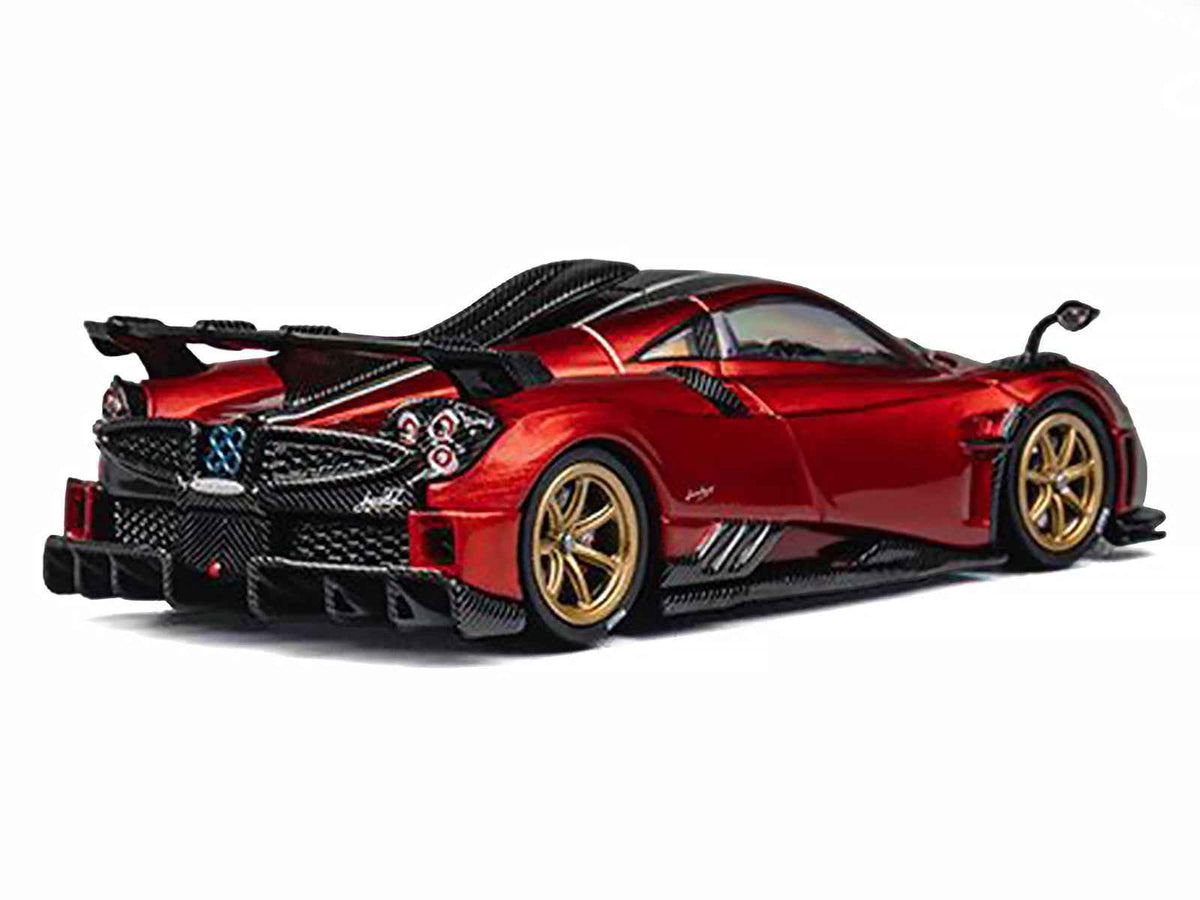 Red metallic Pagani Imola 1/64 diecast model car with carbon top, stripes, and extra wheels by Miniature Motors.