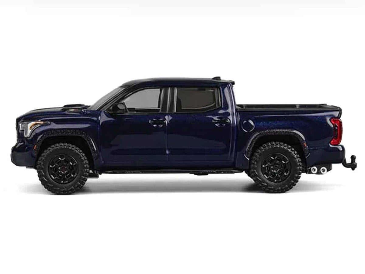 Dark blue metallic Toyota Tundra 1/64 diecast model truck by Miniature Motors, detailed toy pickup truck displayed from the side.