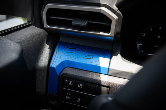 Vinyl interior 3-piece topographic map dash overlays for 2024+ Toyota Tacoma by StickerFab, featuring detailed map designs.