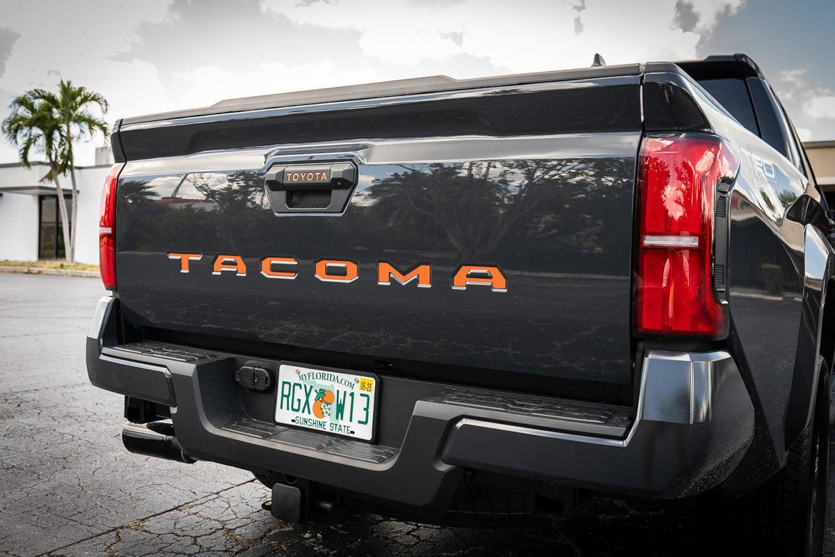 2024+ Toyota Tacoma tailgate handle inlay letters with standard vinyl from StickerFab, showing close-up of exterior vinyl lettering on tailgate