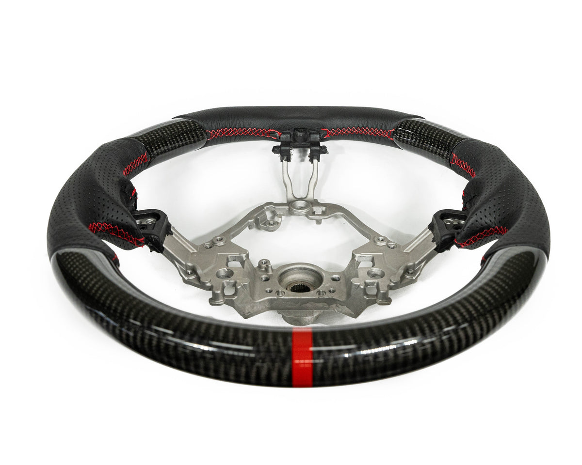 FactionFab steering wheel with carbon fiber and leather, compatible with Subaru BRZ and Toyota 86, shown in close-up view.