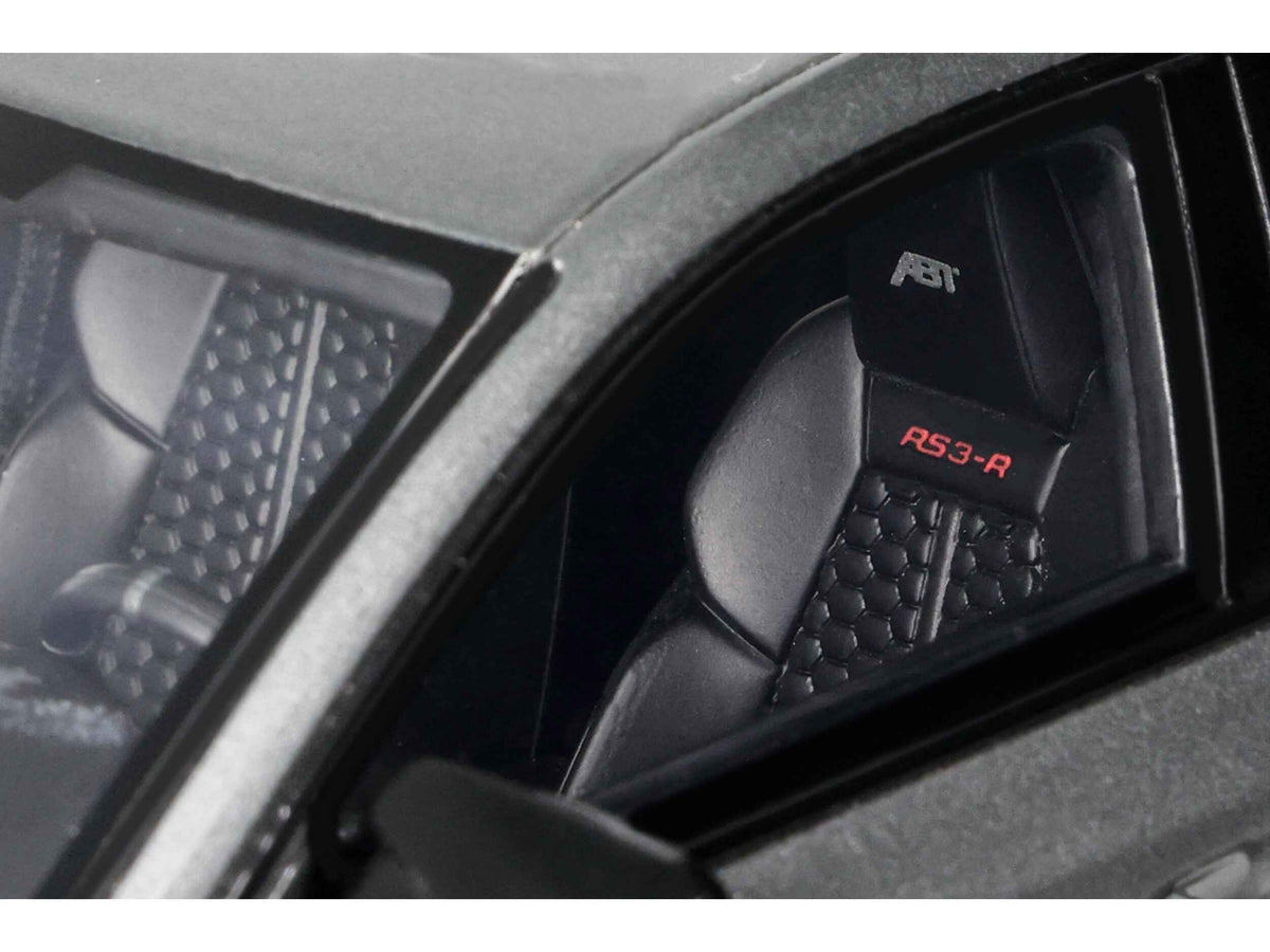 Miniature Audi ABT RS3-R Daytona Gray metallic 1/18 scale model car by GT Spirit, detailed and realistic with intricate features.