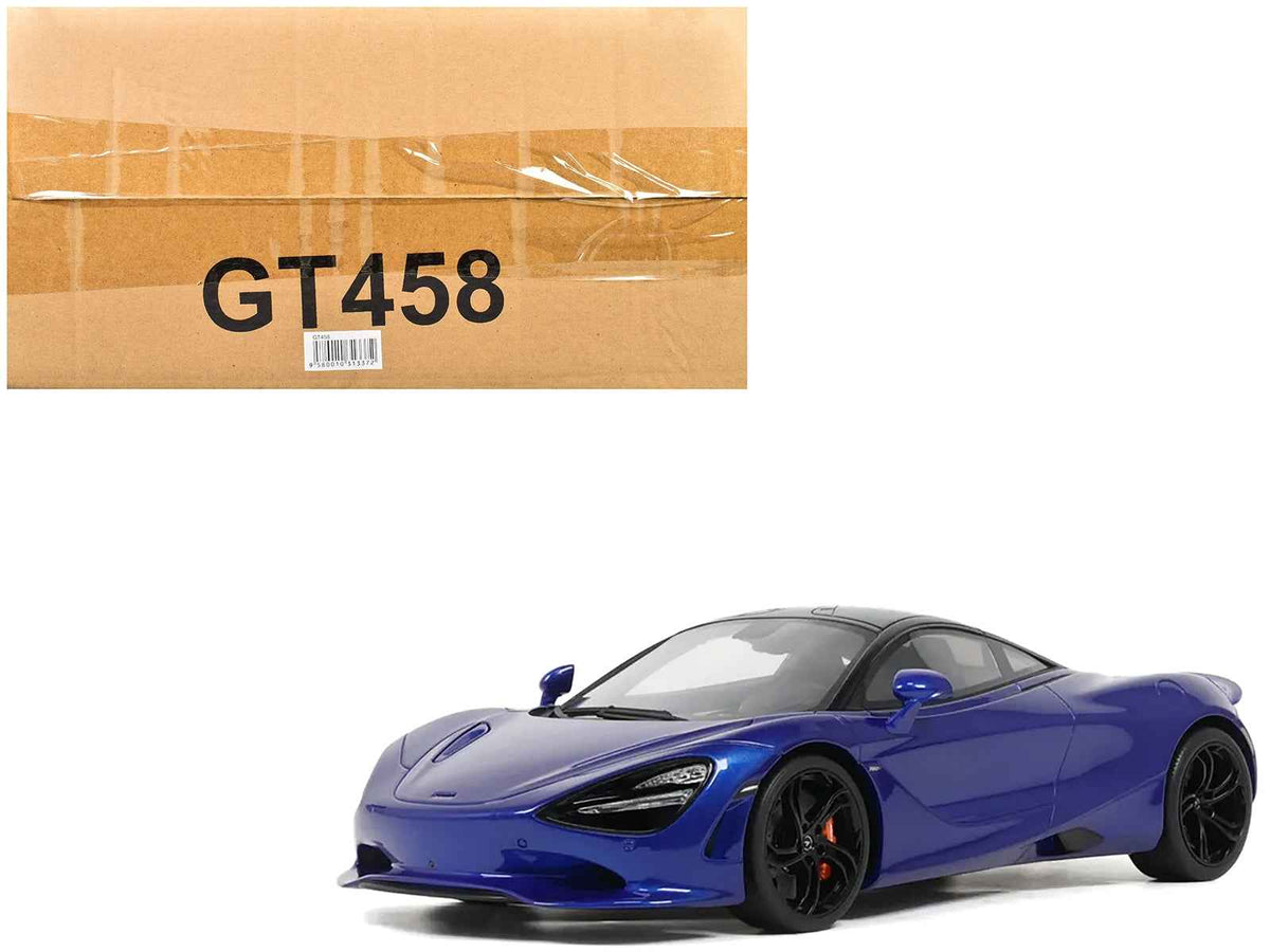 Blue metallic 2023 McLaren 750S coupe model car by GT Spirit, 1/18 scale, with black roof, detailed miniature vehicle.