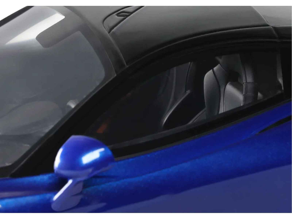 Blue metallic 2023 McLaren 750S Coupe model car by GT Spirit, with black top, 1/18 scale, detailed miniature vehicle.