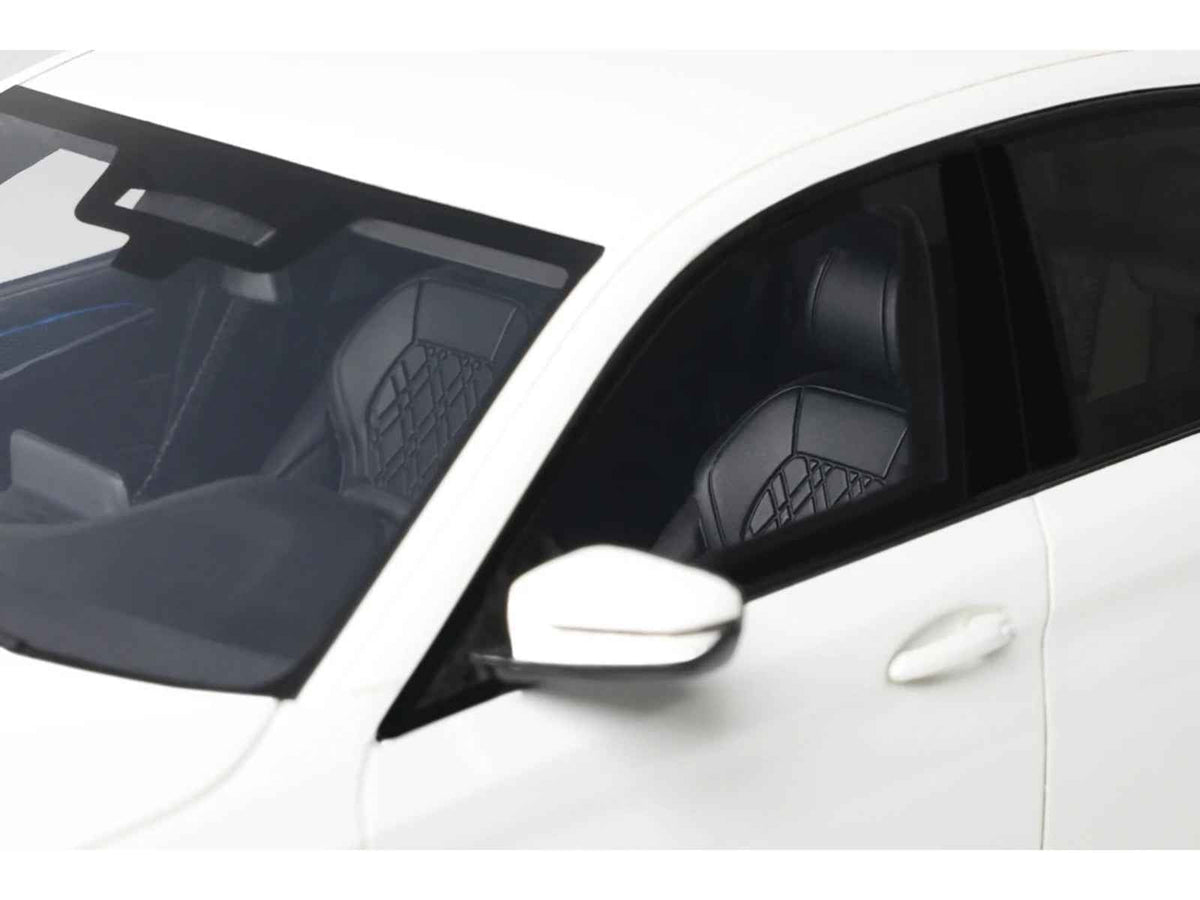 Miniature BMW 545e xDrive M Sport model car in Alpine White by GT Spirit, detailed 1/18 scale collectible vehicle.