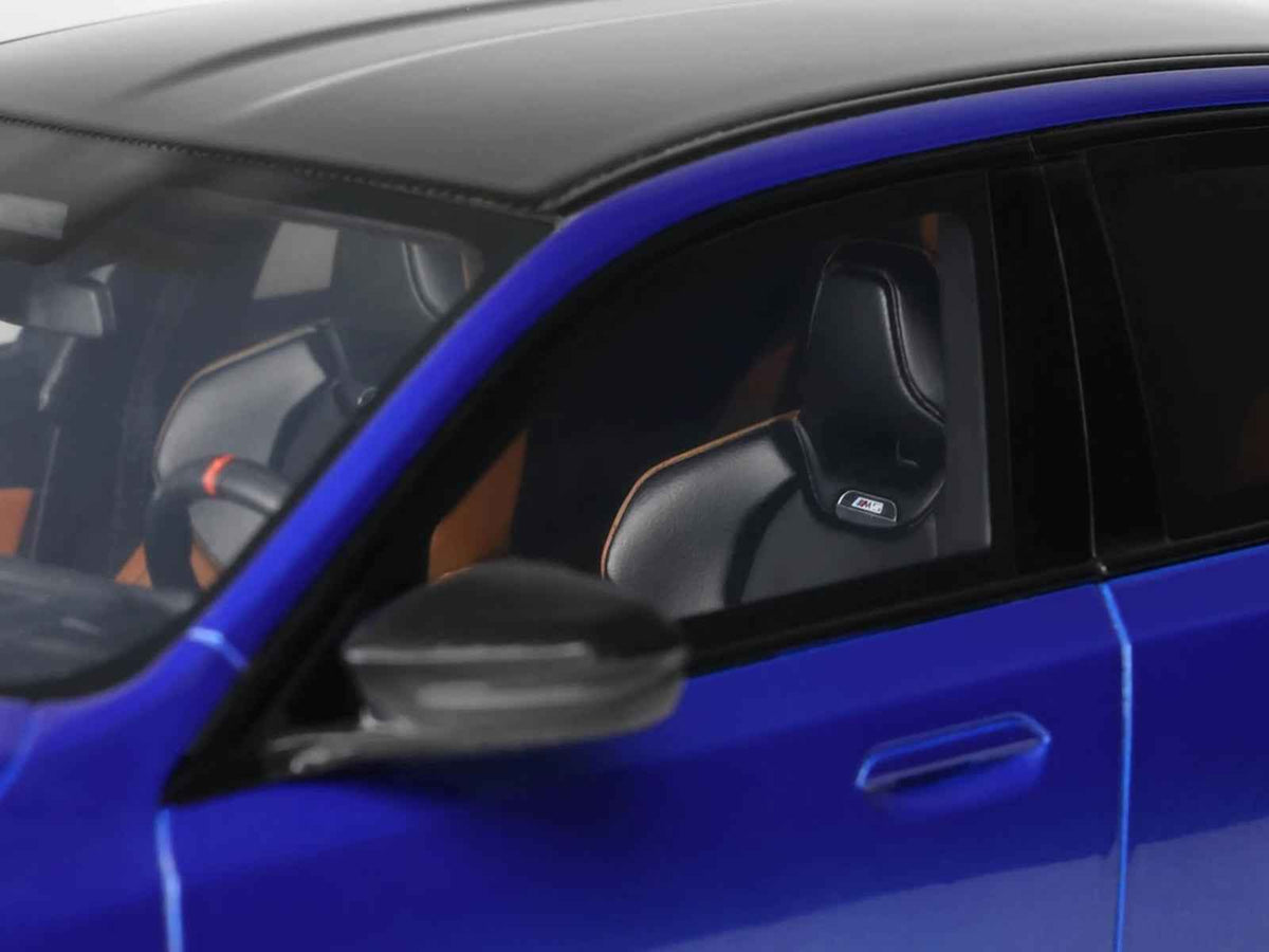Miniature 1/18 BMW M5 G90 model car in Marina Bay Blue Metallic with black top by GT Spirit, detailed scale automotive replica.