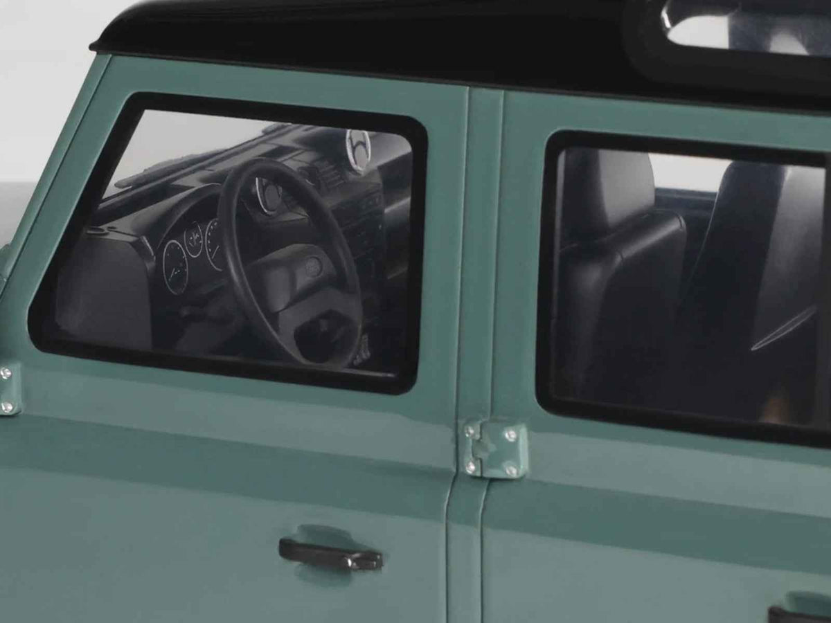 Green 2016 Land Rover Defender 3 Station Wagon miniature model car by GT Spirit, detailed with black top, 1/18 scale.