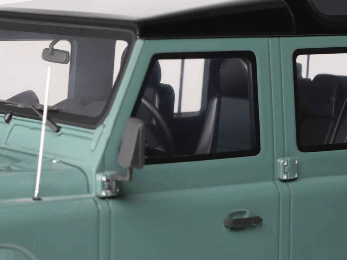 2016 Land Rover Defender 3 Station Wagon miniature model car in green with black top by GT Spirit, 1/18 scale, detailed collectible.