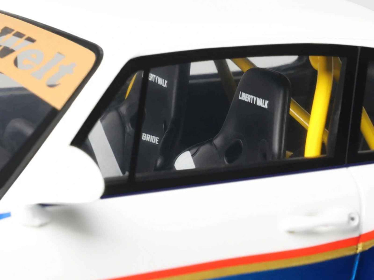 Miniature 1/18 model car of 2023 RWB x Liberty Walk Porsche 993 in white and blue metallic with graphics by GT Spirit