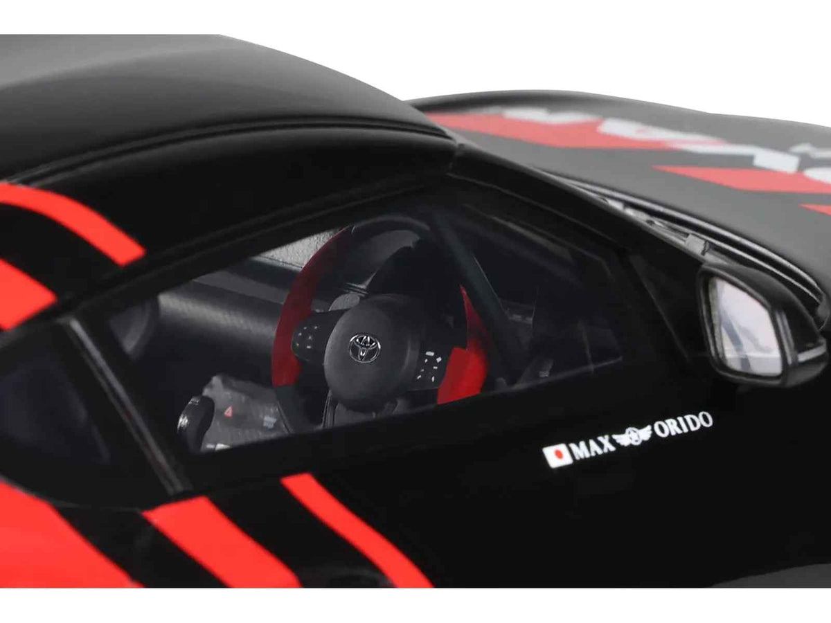 Black and red 1/18 scale Toyota Supra GR RHD model car by GT Spirit, detailed miniature replica for collectors.