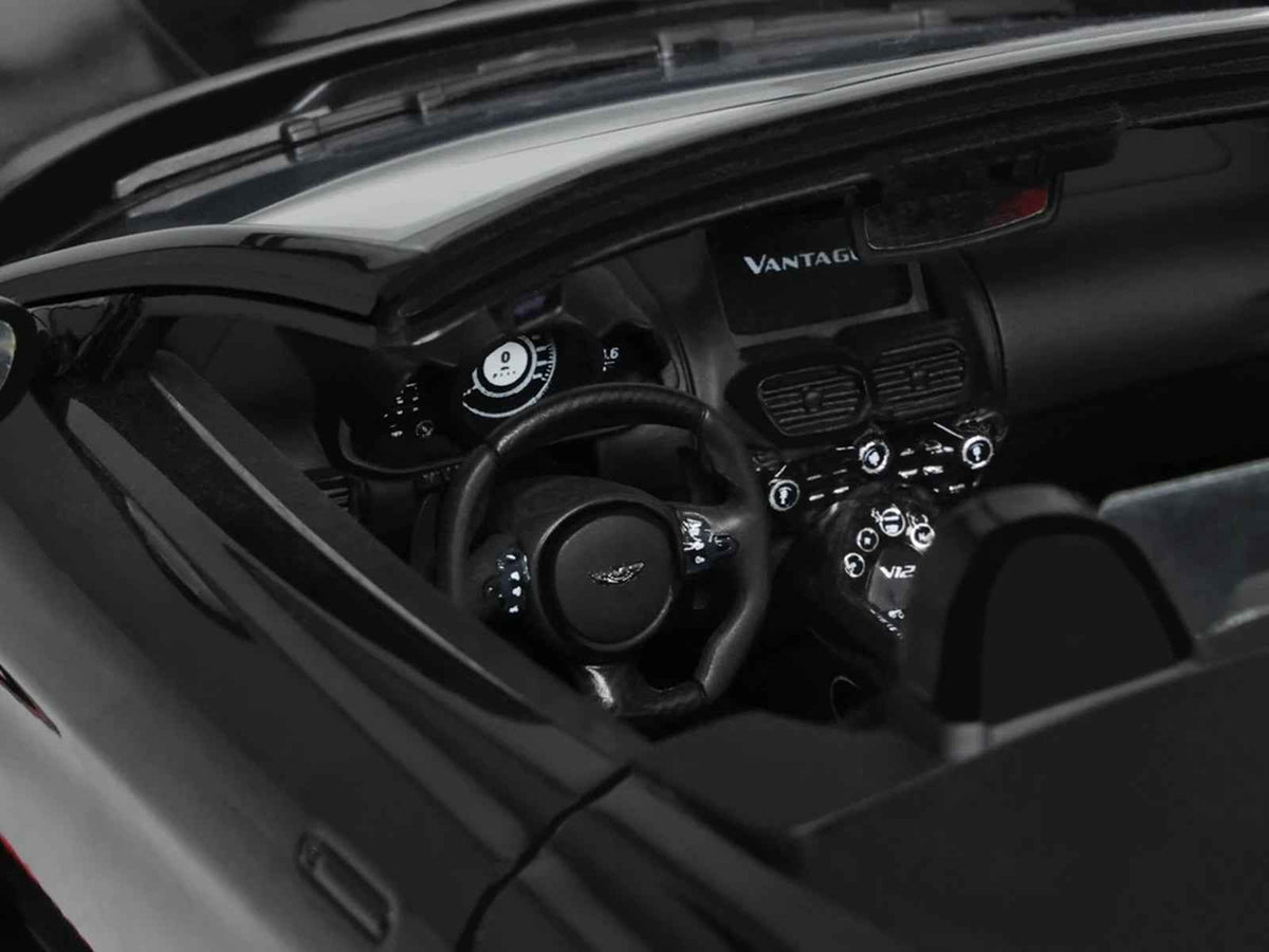 Miniature Aston Martin V12 Vantage Roadster 1/18 scale model in Onyx Black by GT Spirit, detailed collectible car replica.