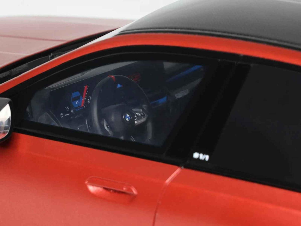 2025 BMW M5 G90 Pebble Beach Edition miniature model car by GT Spirit, Fire Orange Metallic with black top, 1/18 scale.