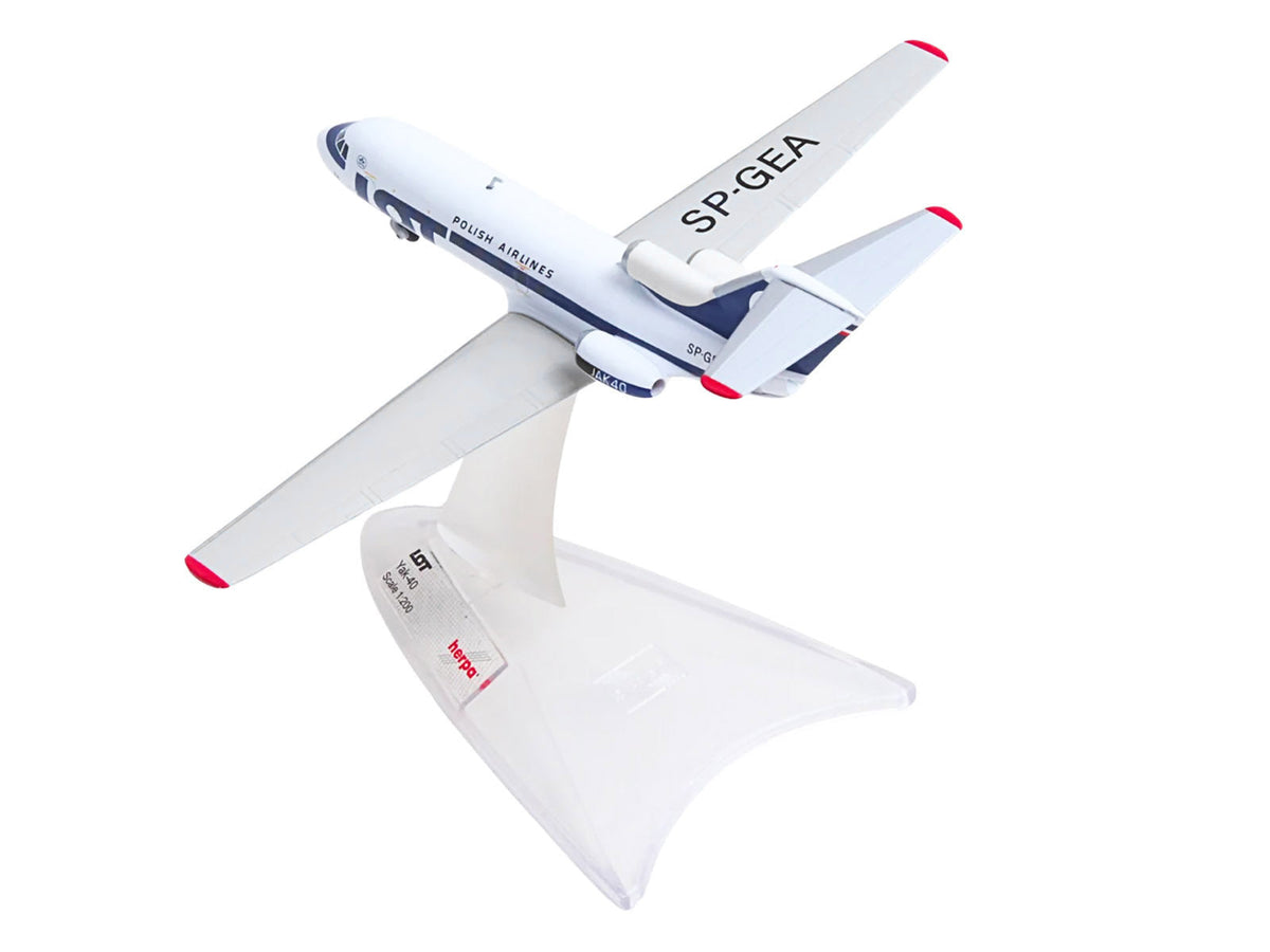 Miniature Herpa Yakovlev Yak-40 aircraft model in white with blue stripes and tail, representing LOT Polish Airlines, 1/200 scale.
