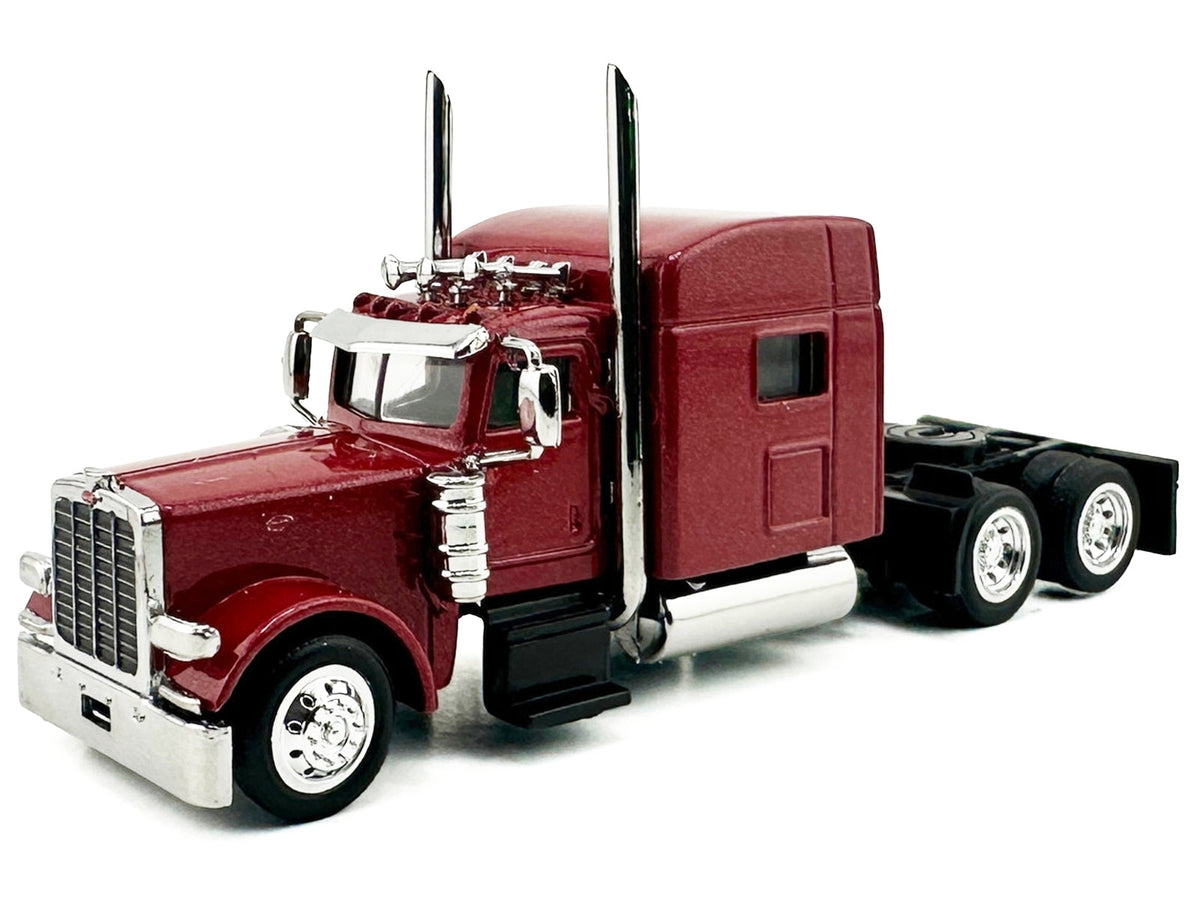 Red metallic Peterbilt 389 truck tractor with sleeper cab, HO scale plastic model by Miniature Motors, detailed miniature vehicle.