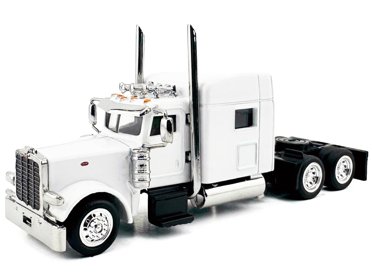 White Peterbilt 389 truck tractor model with sleeper cab in 1/87 scale, detailed plastic model by Miniature Motors.