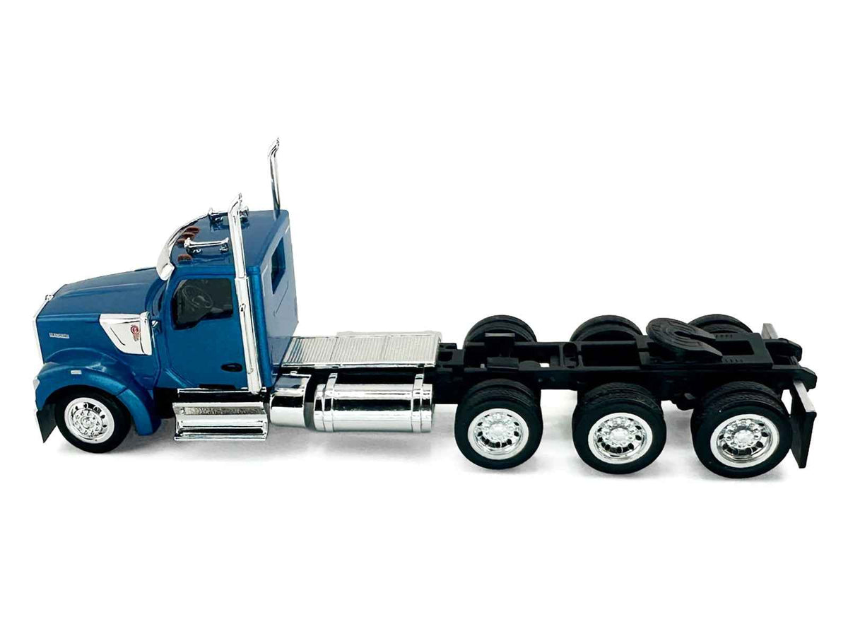 Blue metallic Kenworth W990 3-axel day cab model truck in 1/87 scale by Miniature Motors, detailed HO Logistics plastic model.