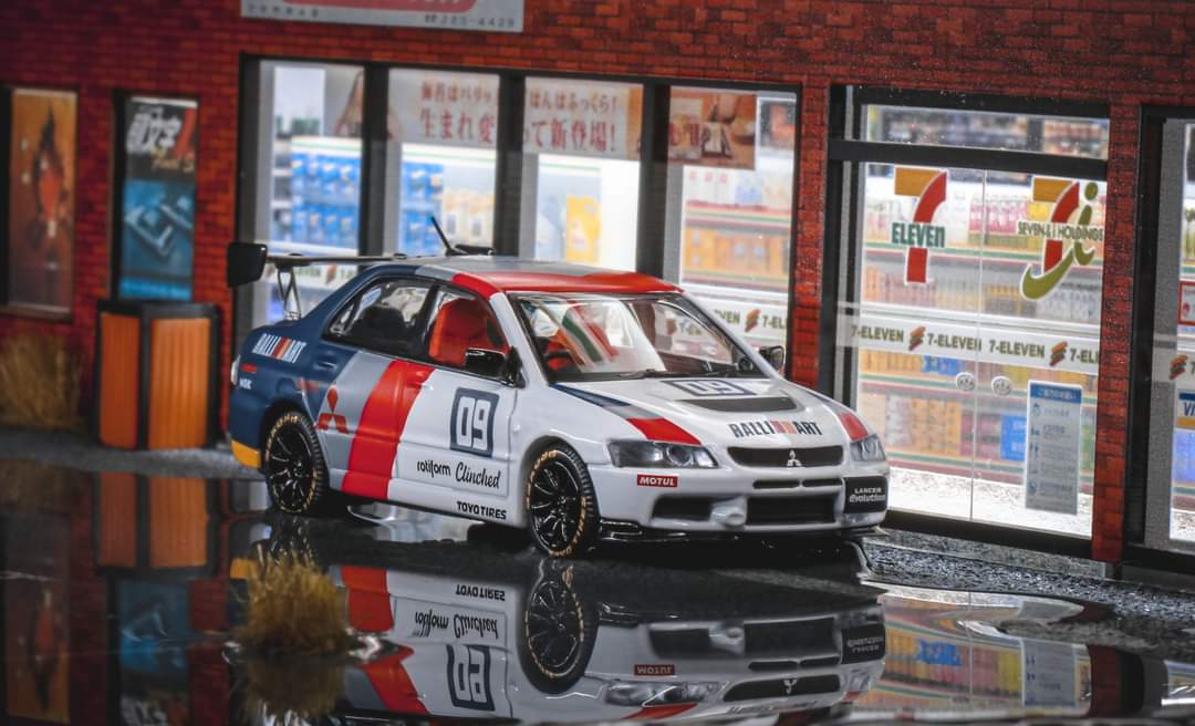 Diecast Mitsubishi Evolution 9 Ralliart model car in 1:64 scale from Speed GT, detailed red and white design, collectible toy.