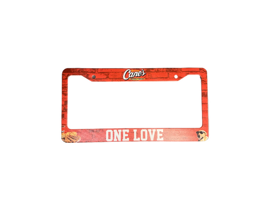 Bad Taste Worldwide Raising Cane's license plate frame, durable metal car accessory with Raising Cane's logo and branding.