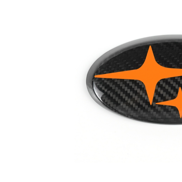 JDMuscle carbon fiber emblem covers for 2022-2025 WRX and 2015-2021 WRX/STI, front and back, designed for Toyota GR86 and BRZ.