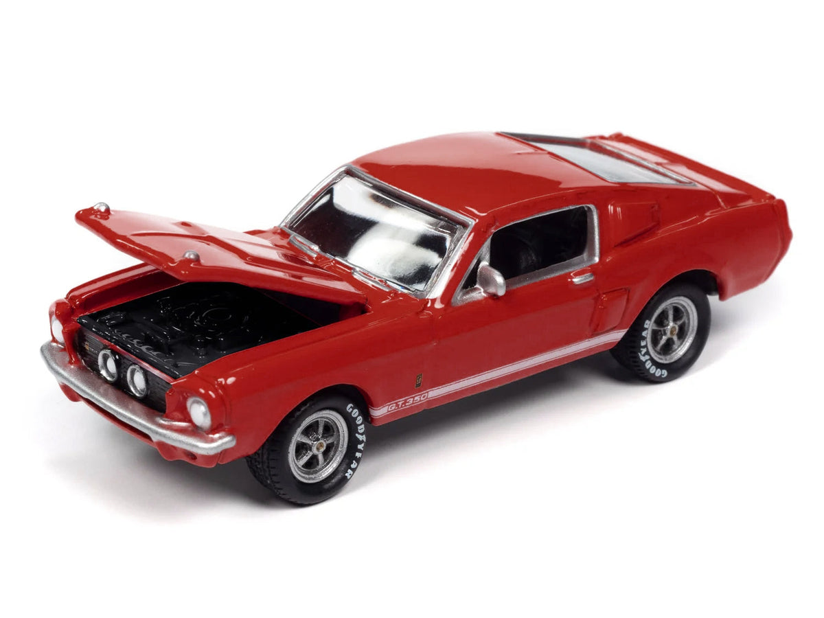 Red 1967 Shelby GT-350 diecast model car with white side stripes by Johnny Lightning, part of Miniature Motors Shelby models collection.
