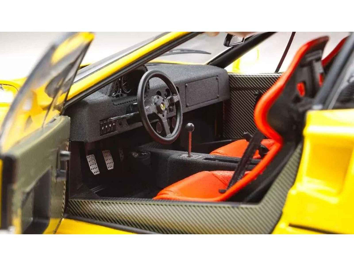 Yellow Ferrari F40 diecast model car in 1/18 scale by Kyosho, detailed miniature Ferrari model on a white background.