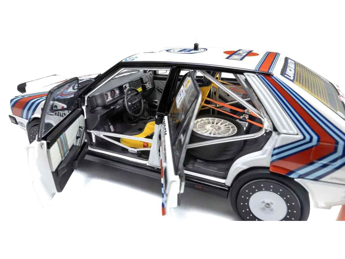 Lancia Delta HF 4WD Martini Racing diecast model car by Kyosho, showcasing detailed miniature of rally winner driven by Bruno Saby.