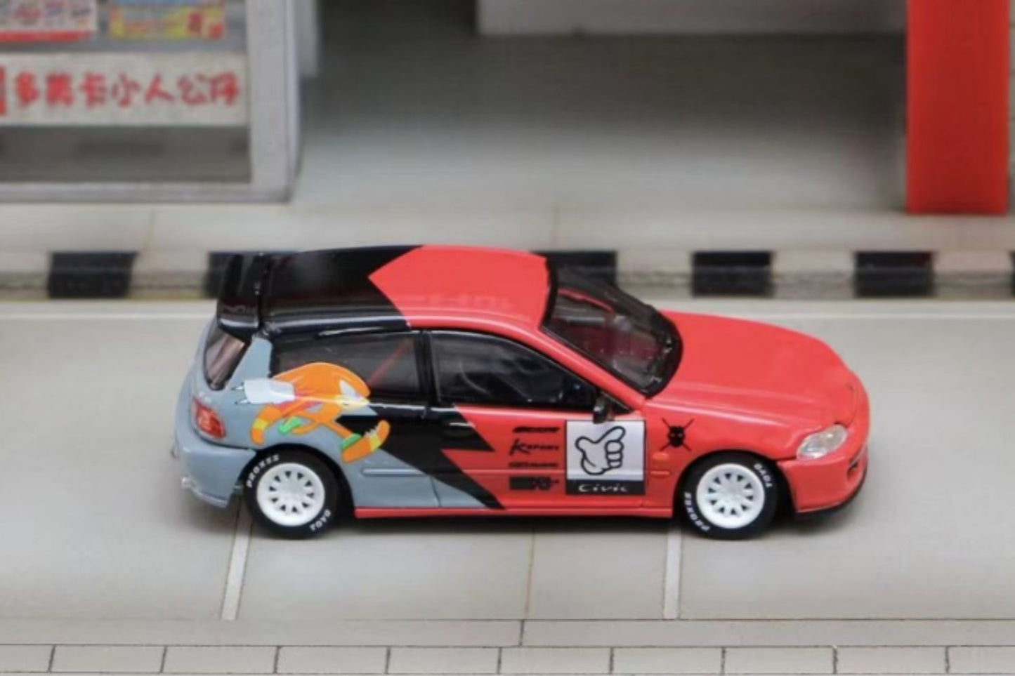 Honda Civic EG6 diecast model in Sonic livery, 1:64 scale, featuring detailed design and vibrant racing graphics.