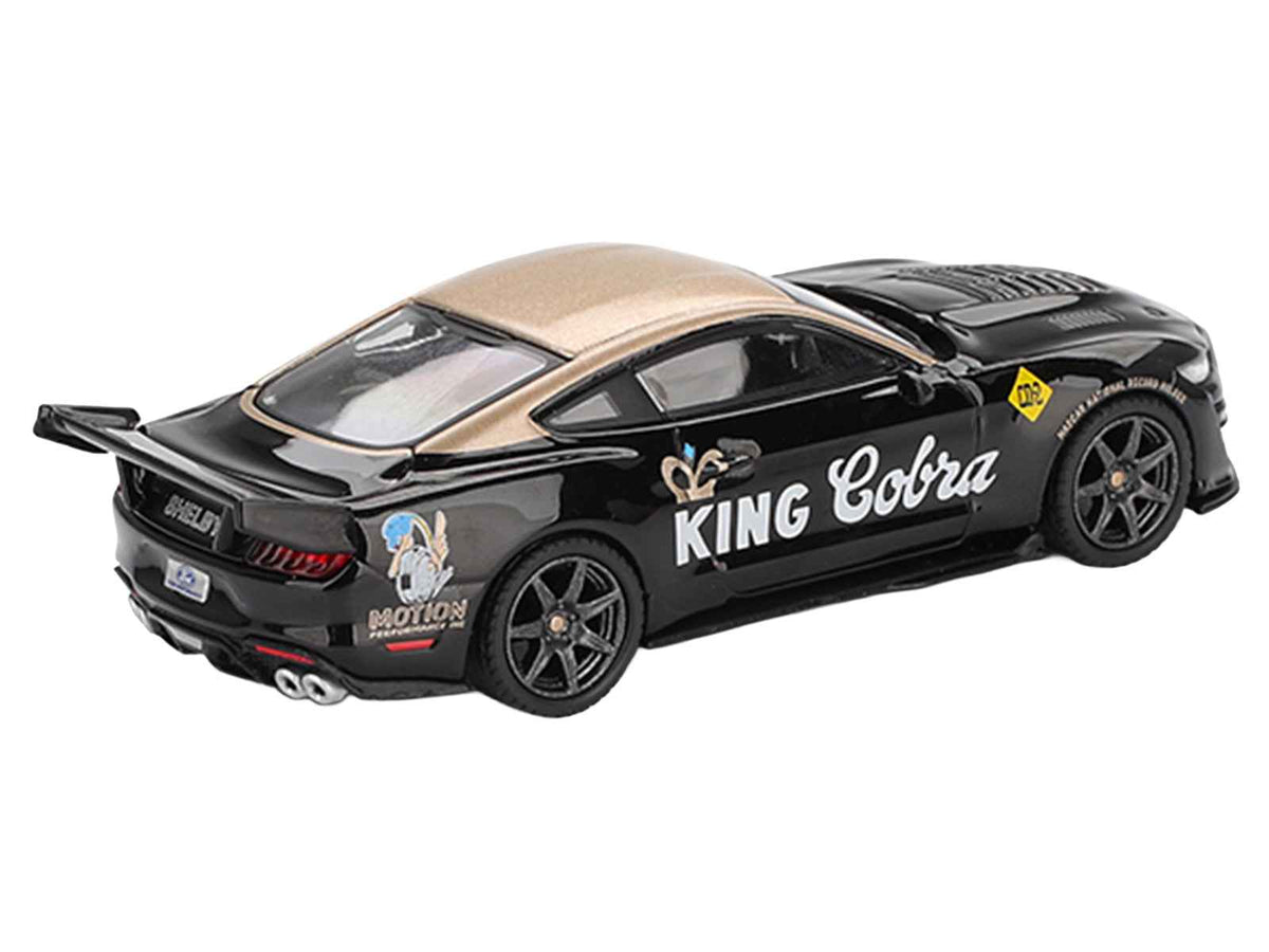 Mini GT Shelby GT500 Dragon Snake Concept diecast model car in black with gold metallic accents, limited edition 1/64 scale.