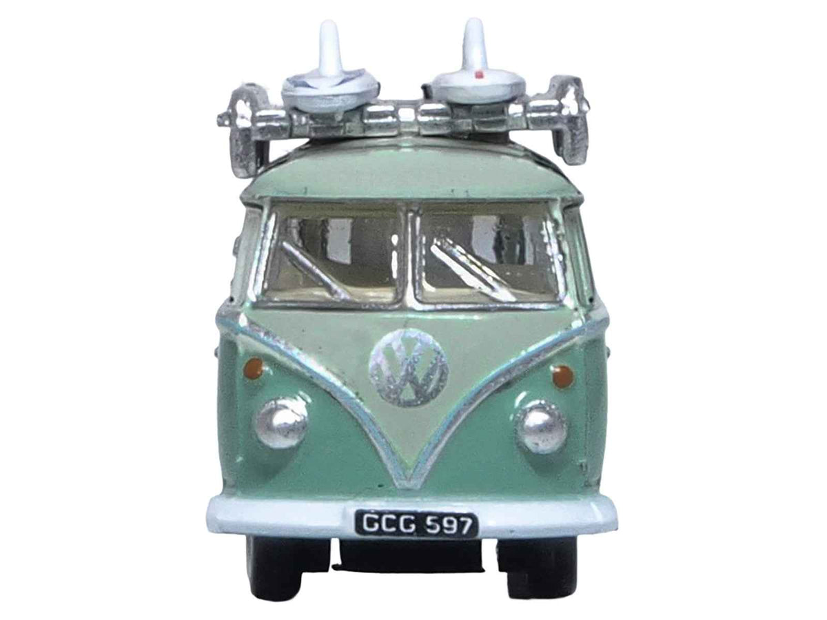 Green Volkswagen T1 Samba Bus diecast model by Oxford Diecast, right-hand drive, two-tone with surfboards on roof rack, N scale.