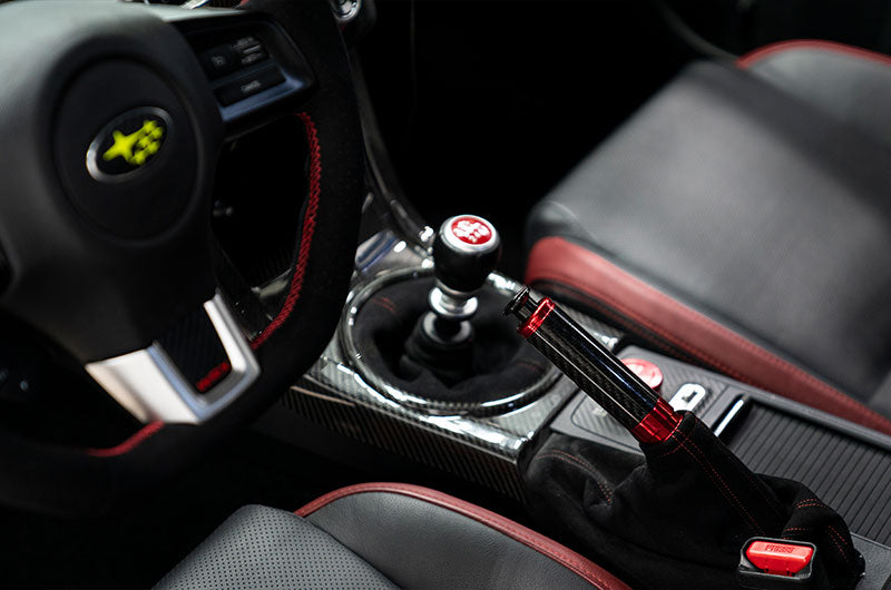 OLM Signature Series E-Brake Handle in red and black carbon for Subaru BRZ, WRX, and STI