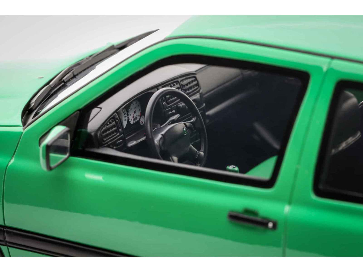 Miniature 1995 Volkswagen Golf III GTI Salsa Green 1/18 scale model car by Otto Mobile, detailed collectible vehicle.