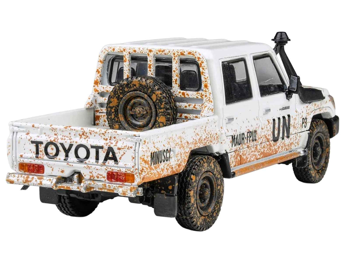 White 1/64 Toyota Land Cruiser LC 79 pickup truck diecast model by Miniature Motors, detailed miniature vehicle with "UN MINUSCA" markings.