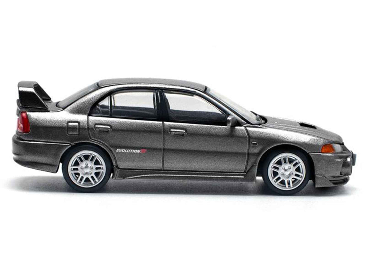 Miniature Motors Mitsubishi Lancer Evolution IV RHD diecast model car in dark gray metallic, 1/64 scale, by Pop Race.
