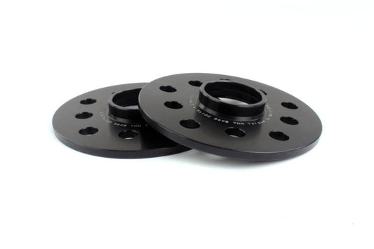 Black PERRIN 7mm wheel spacers for Subaru WRX, STI, Outback, Legacy, and Forester, shown on a vehicle wheel.