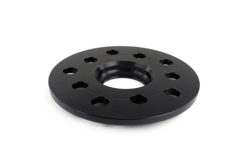JDMuscle black 7mm wheel spacers for Subaru WRX, STI, Outback, Legacy, and Forester, shown installed on vehicle wheels.