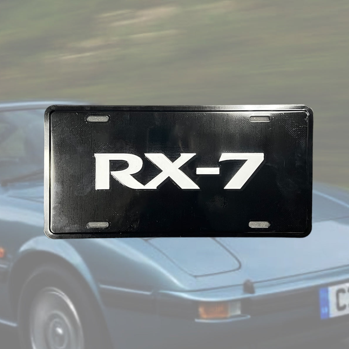 Illumaesthetic RX7 dealer license plate featuring a sleek design on a standard metal plate, ideal for vehicle identification.