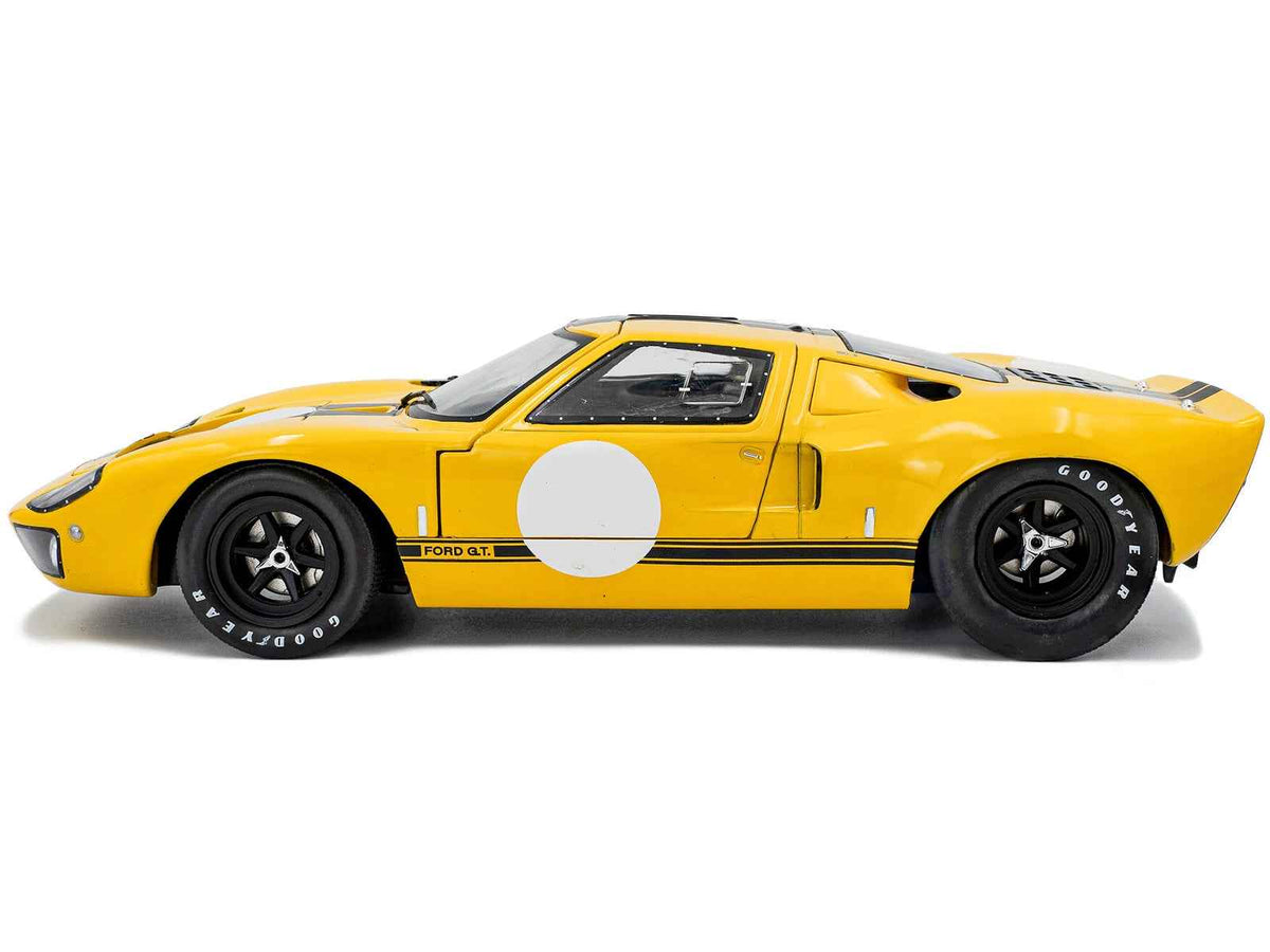 Yellow 1968 Ford GT40 MK1 diecast model car with black stripes, part of the Solido "Competition" Series, 1/18 scale by Miniature Motors.