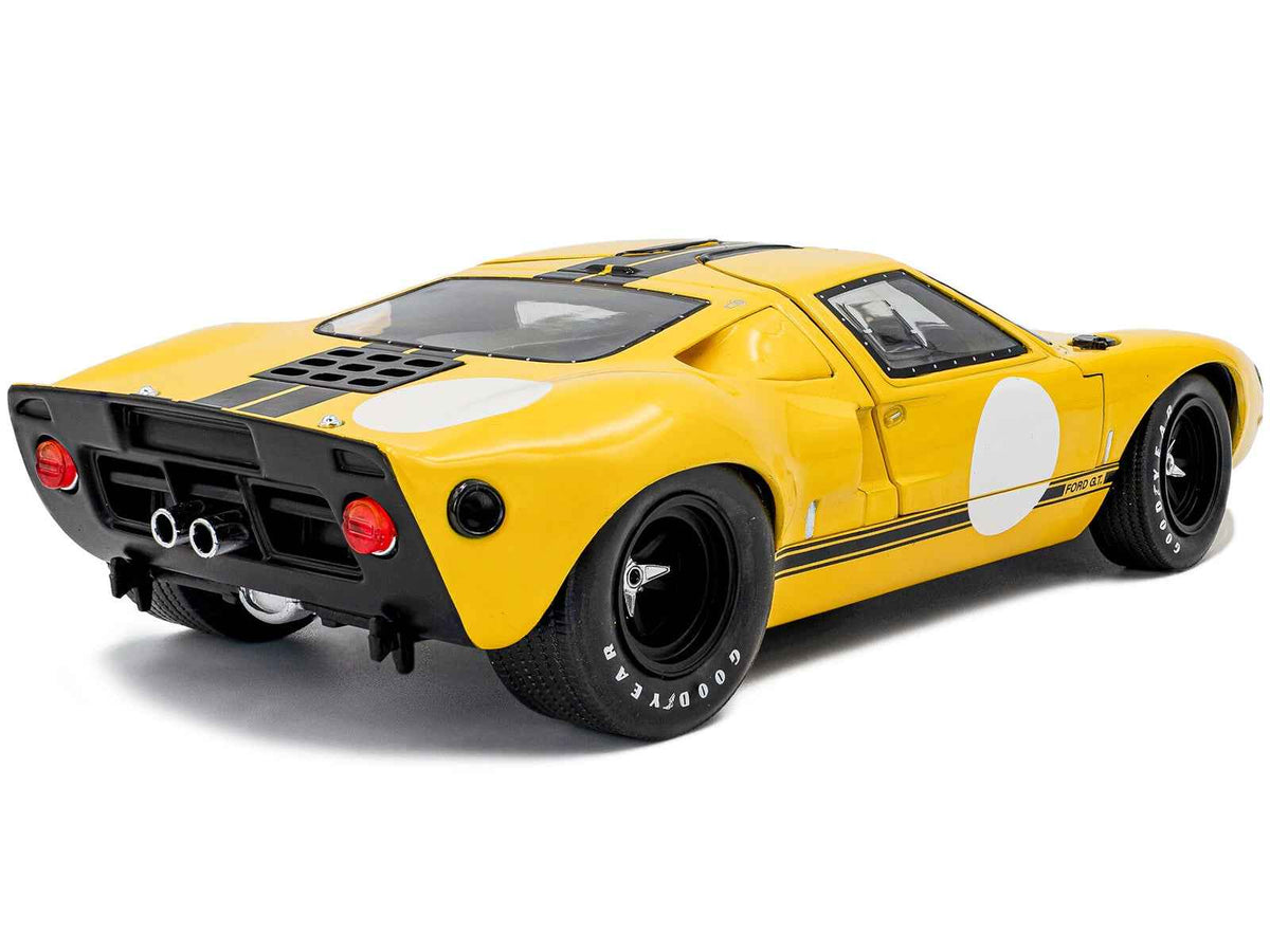 Yellow 1968 Ford GT40 MK1 diecast model car with black stripes, part of Solido's "Competition" Series, 1/18 scale by Miniature Motors.