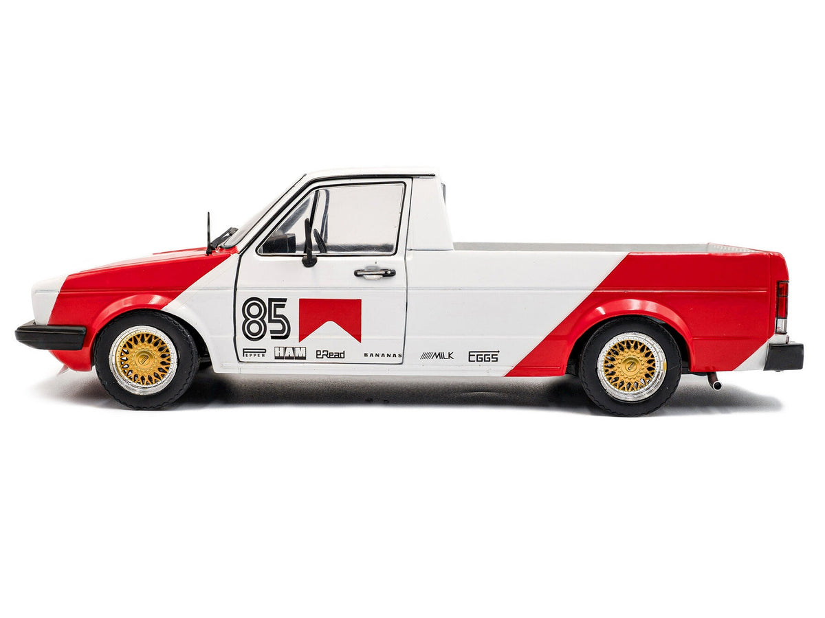 White and red 1/18 scale Volkswagen Caddy MK 1 pickup diecast model by Solido, featuring "Red Cowboy Racing Tribute" design.